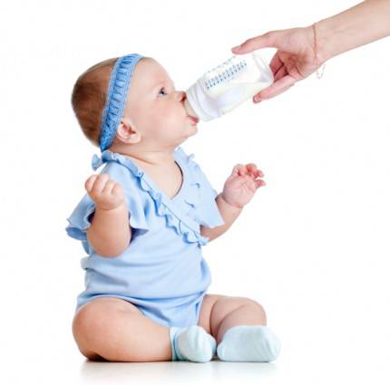 latte vaccino - adorable baby girl drinking from bottle with help of mother