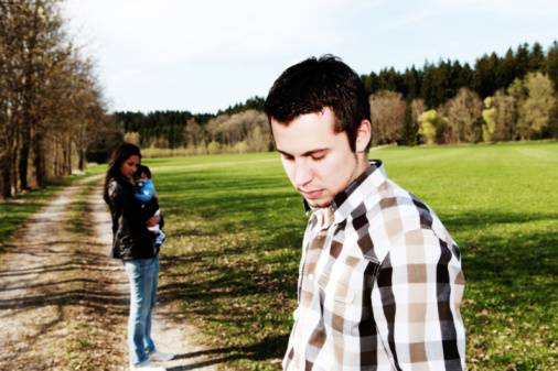 sad man standing aside from woman with baby, divorce